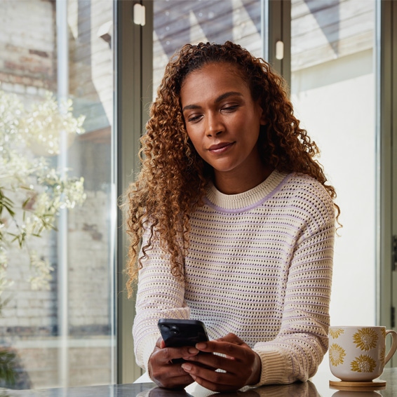 Woman checking her Yale Home App on her Smartphone