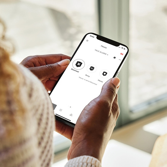Woman looking on the Yale Home App on her smart phone